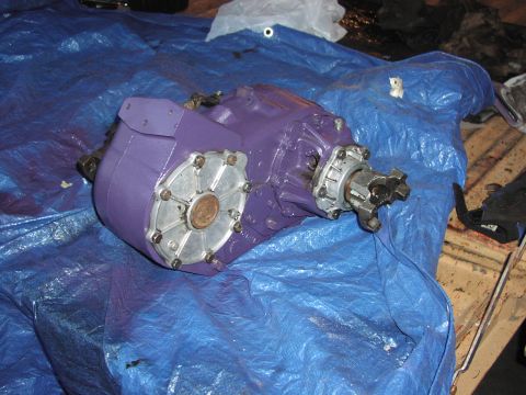 1979 Ford Bronco - A purple painted transfer case sits on a blue tarp, likely awaiting installation or repair.