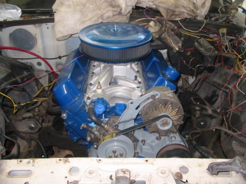 1985 Ford LTD Crown Victoria - The engine bay shows a blue V8 engine with a large air filter and various wires and components.
