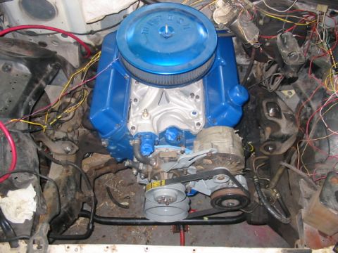 1985 Ford LTD Crown Victoria - Engine bay view showing a blue engine, alternator, and extensive wiring.