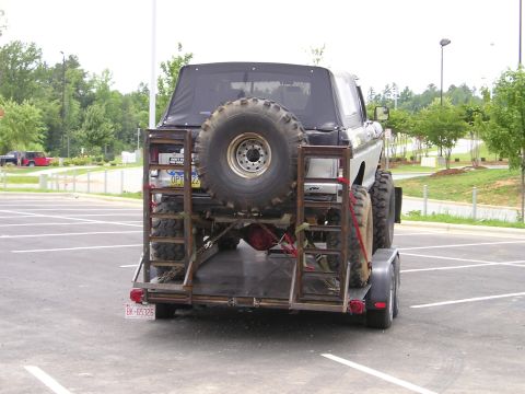1996 Ford Bronco - This 1996 Ford Bronco is being transported on a trailer, showing its rear profile and spare tire.