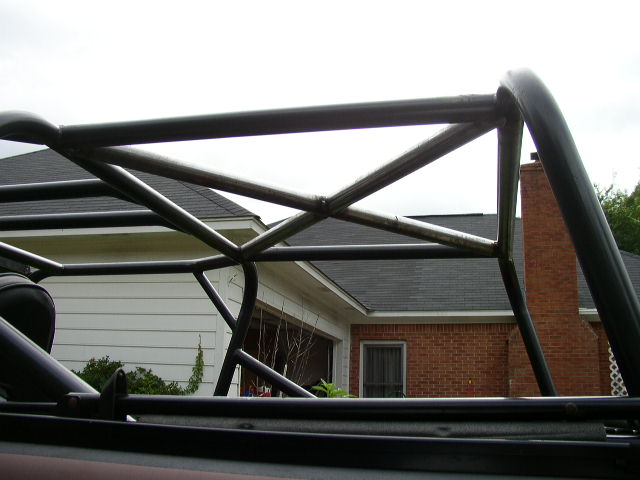 Roll cage structure over a house and garage