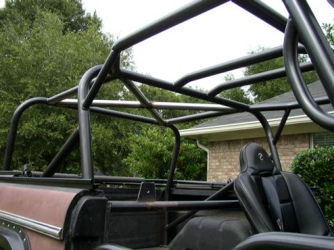 1995 Ford Bronco - Custom roll cage installed on a vehicle, viewed from the rear passenger side.