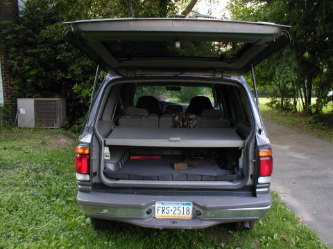 1979 Ford Bronco - The rear of an SUV is shown with its hatch open, revealing the cargo area and a Pennsylvania license plate.