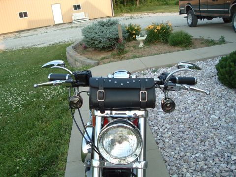 2002 Harley-Davidson Sportster Custom - Front view of motorcycle handlebars a black leather tool bag and chrome accents.