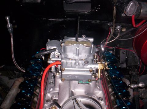 1989 Ford Bronco II - Close-up of a Holley carburetor installed on an engine, blue valve covers and various fuel lines.