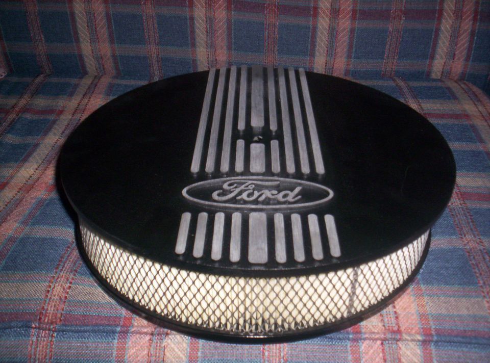 Ford oval logo on black air cleaner with silver stripes and mesh filter