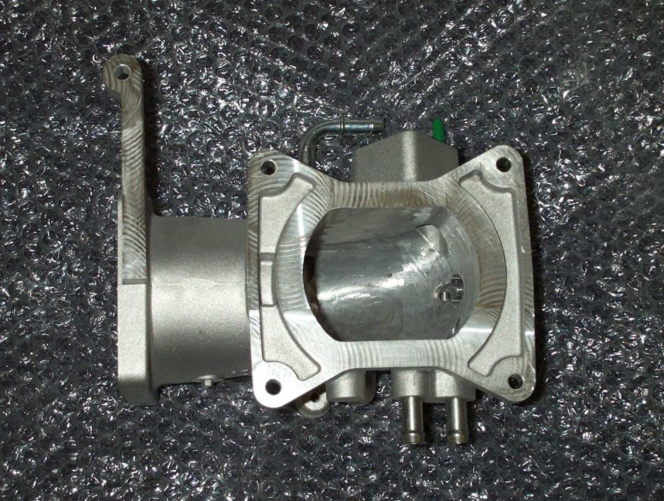 Aluminum throttle body or intake casting photographed on bubble wrap