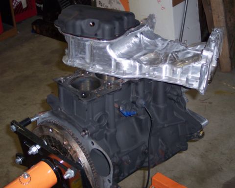 1999 Mitsubishi Mirage - Engine block and intake manifold assembly, likely for a custom build or repair, displayed on an engine stand.