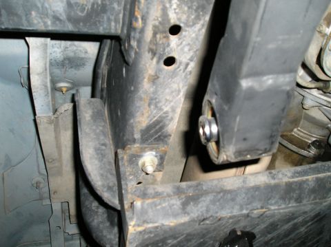 1993 Ford Bronco - Close-up view of the vehicle's undercarriage, focusing on suspension components and frame structure.