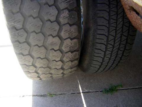 1986 Ford Bronco II - A close-up view of two vehicle tires shows distinct tread patterns on each tire.