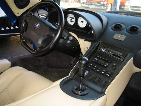 1985 Ford Mustang - Interior view of a car's dashboard and center console with tan seats.