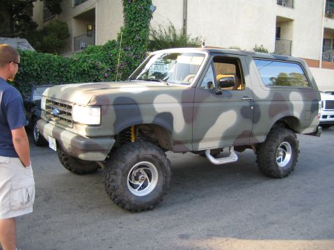 1985 Ford Mustang - This camouflaged Ford Bronco appears to be from the late 1980s, not a 1985 Mustang.