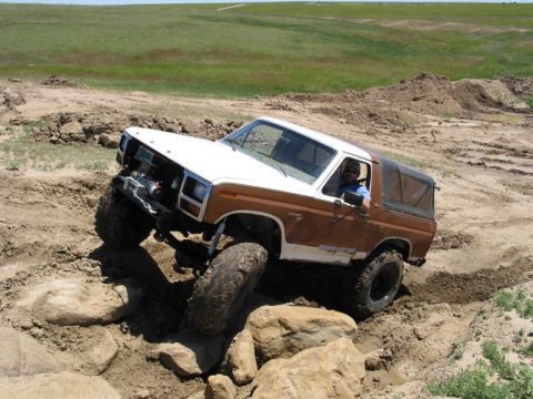 1981 Ford Bronco - This modified Ford Bronco is shown off-roading on a dirt and rock trail.