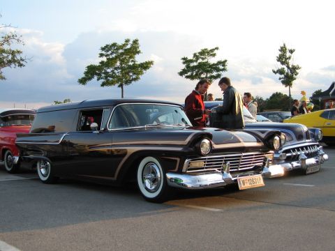 1992 Ford Crown Victoria - A dark sedan delivery van with whitewall tires is parked next to other classic vehicles.