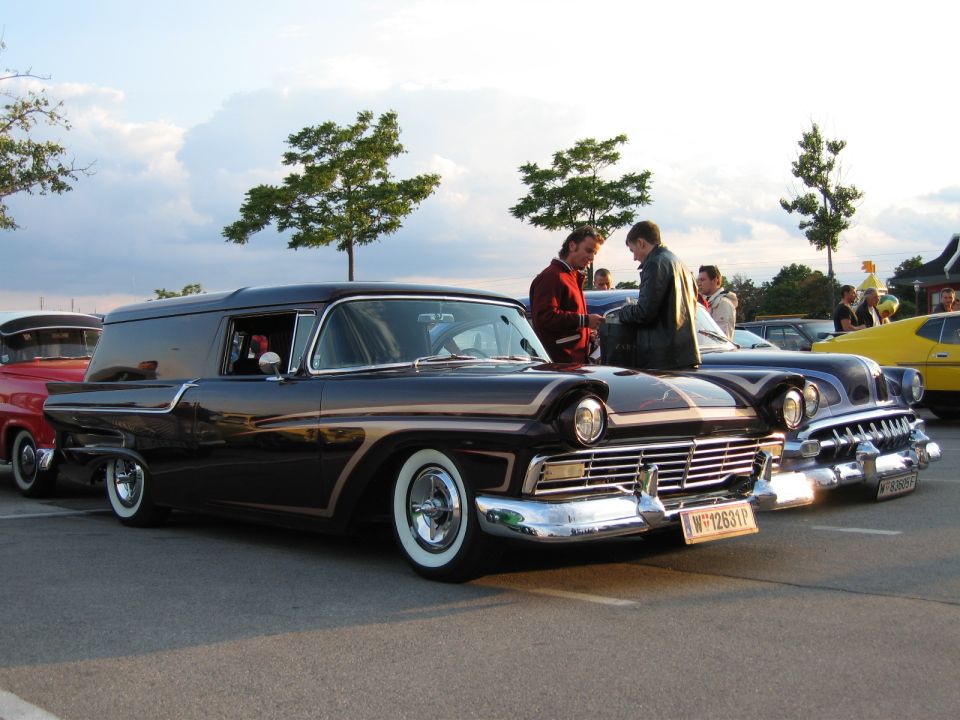 Dark 1957 sedan delivery van with whitewall tires and chrome grille