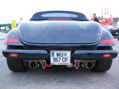 1992 Ford Crown Victoria - The rear of a dark blue Plymouth Prowler is shown, its distinctive dual exhaust and license plate.