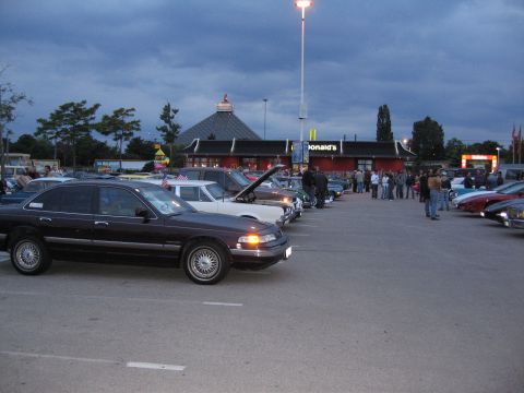 1992 Ford Crown Victoria - A gathering of vehicles in a parking lot with a McDonald's restaurant visible.