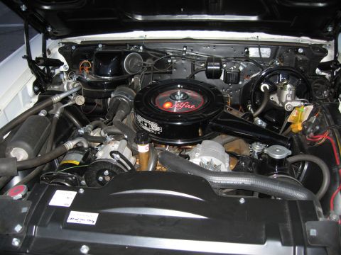 1992 Ford Crown Victoria - The engine bay of a car, a prominent black air cleaner with "Jetfire" branding and various engine components.