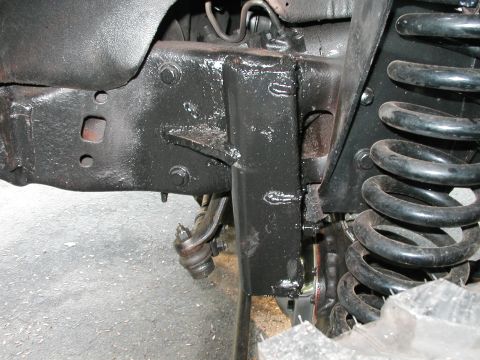 1994 Ford Bronco - Detail of a vehicle's chassis and suspension system, showing frame structure and coil spring.