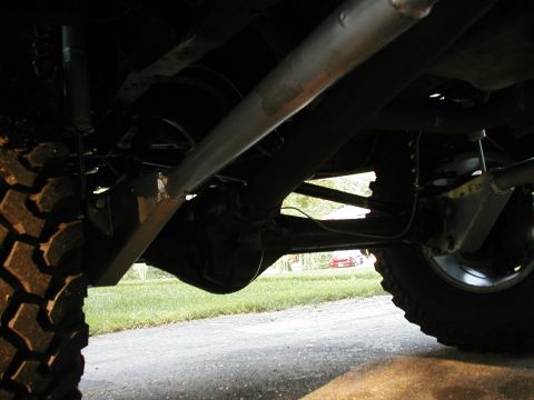 1994 Ford Bronco - The photo shows the undercarriage of a vehicle, focusing on the suspension and rear axle assembly.