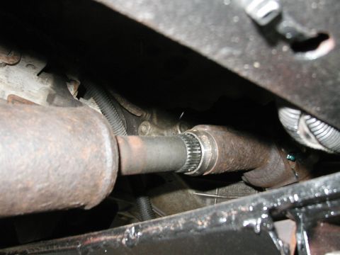 1994 Ford Bronco - Underside view of a vehicle's driveshaft and differential, showing mechanical components and signs of wear.