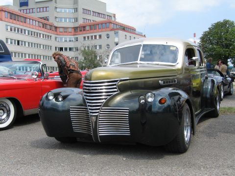 1992 Ford Crown Victoria - A customized vintage car with a unique grille and fender design is displayed at an outdoor event.