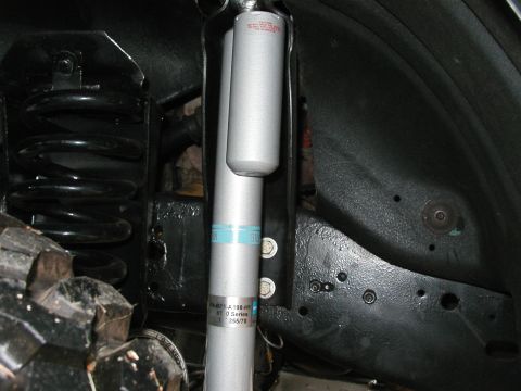 1994 Ford Bronco - The photo shows a close-up of the rear suspension system, including a shock absorber and coil spring.