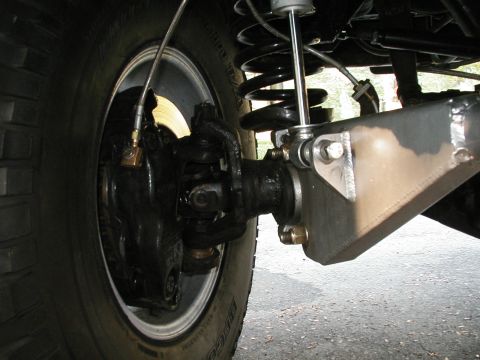 1994 Ford Bronco - Detail of off-road vehicle suspension and axle components, including brake and steering linkage.