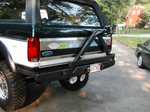 1994 Ford Bronco - The rear of a Ford Bronco shows an aftermarket bumper and spare tire mount, with a license plate reading '34Z NOO'.