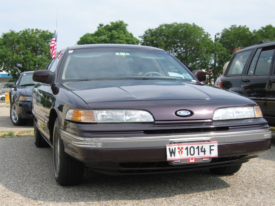 Dark purple 1992 Ford Crown Victoria with a license plate W 1014 F, parked outdoors