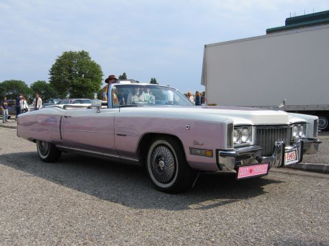 1992 Ford Crown Victoria - A two-tone convertible with people inside is parked on a gravel lot.