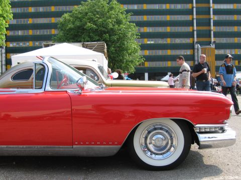 1992 Ford Crown Victoria - A red 1957 Cadillac Eldorado convertible is parked next to another classic car.