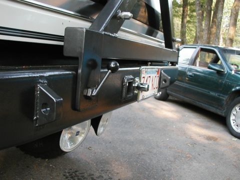 1994 Ford Bronco - A custom rear bumper assembly is shown, a tow hitch and a Massachusetts license plate. Another vehicle is visible in the background.