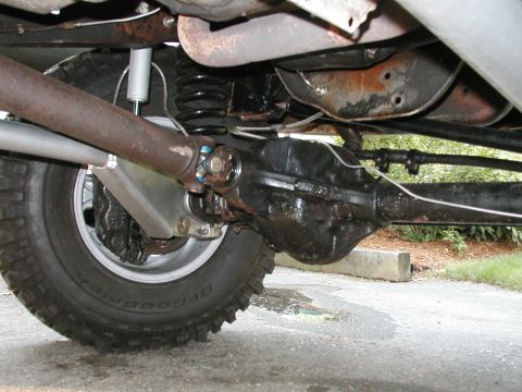 1994 Ford Bronco - Close-up of the rear axle assembly and suspension of an older vehicle.