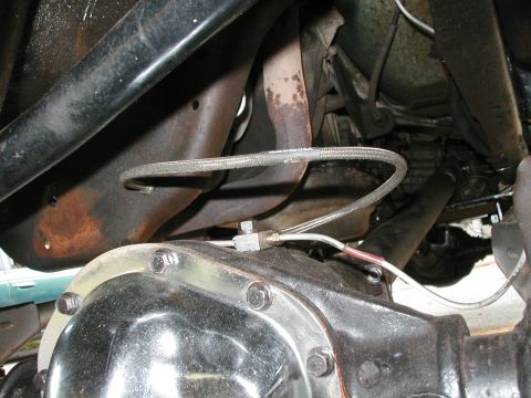 1994 Ford Bronco - Close-up view of a vehicle's undercarriage, focusing on the rear differential and exhaust components.