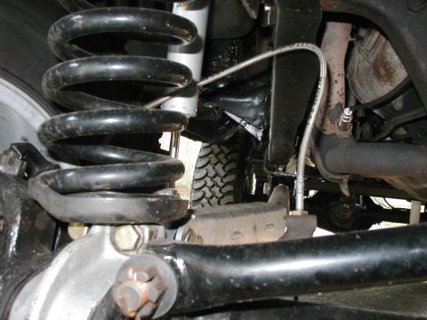 1994 Ford Bronco - Close-up view of the undercarriage, focusing on the suspension and exhaust components.