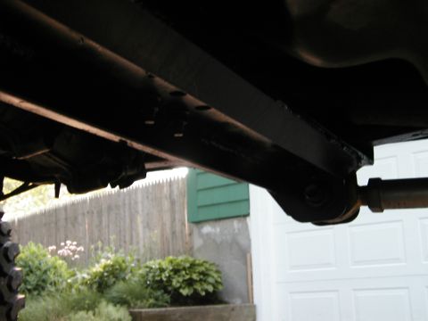 1994 Ford Bronco - A close-up shot reveals the underside of a vehicle, focusing on its frame and suspension system.