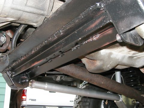1994 Ford Bronco - Close-up of vehicle undercarriage, focusing on frame and exhaust components.