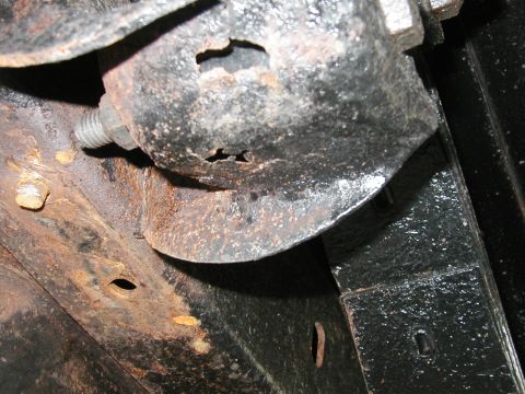 1994 Ford Bronco - Detail of heavily rusted undercarriage components, showing corrosion and structural damage.
