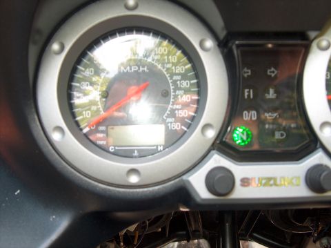 2002 Suzuki TL1000R - Close-up of a motorcycle's dashboard, the Suzuki logo, a speedometer, and various indicator lights including neutral and FI.