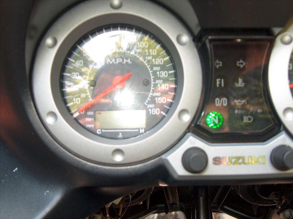 Suzuki motorcycle gauge cluster with MPH speedometer and green neutral indicator lit
