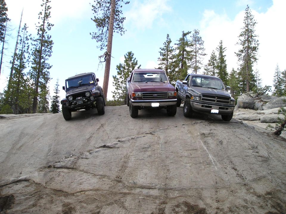 Dark gray Dodge Ram pickup truck parked on a rocky slope