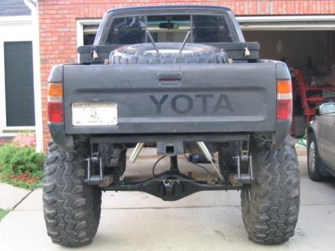 1986 Ford F-150 - This modified Toyota pickup truck has a lifted suspension and oversized off-road tires.