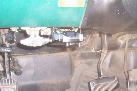1994 Ford F-150 - Close-up view of the ignition and pedals within a vehicle's interior.