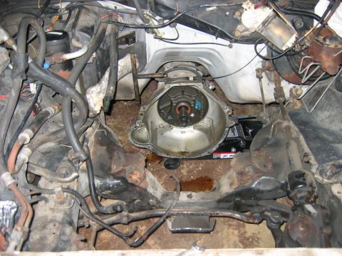 1985 Ford Crown Victoria LTD - The engine bay is partially disassembled, with the transmission assembly exposed and components around it.