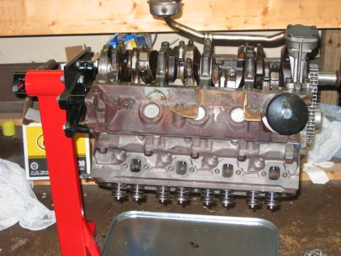 1985 Ford Crown Victoria LTD - Engine block assembly on a red stand, with crankshaft and cylinder heads visible.