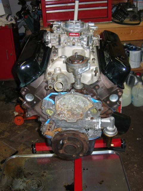 1985 Ford Crown Victoria LTD - V8 engine on stand, likely undergoing rebuild or swap. Edelbrock carburetor visible.