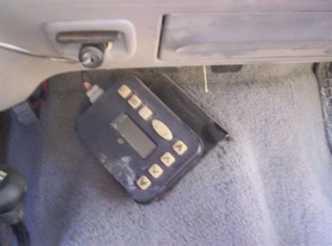 1995 Ford F-250 - An aftermarket controller with multiple buttons and a small display is visible on the floor of a vehicle's interior.
