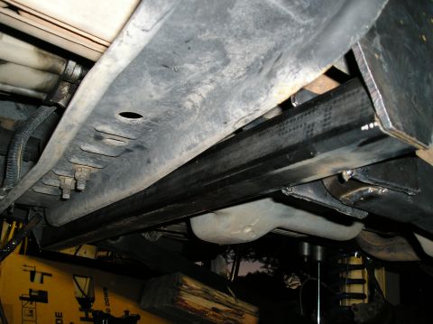 1993 Ford Bronco - Close-up view of the undercarriage of a vehicle, highlighting the frame and suspension system.