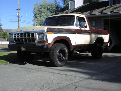 1979 Ford Bronco - A two-tone tan and brown Ford Bronco is parked in a driveway on a sunny day.